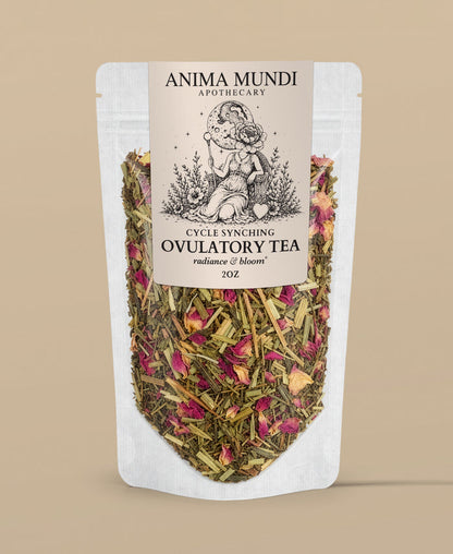 A stand-up pouch of Anima Mundi Apothecary Cycle Syncing Ovulatory Tea, featuring a cream-colored label with black text and an illustration of a woman holding a flower, with visible dried herbs and pink rose petals inside a clear lower section, set against a solid beige background.