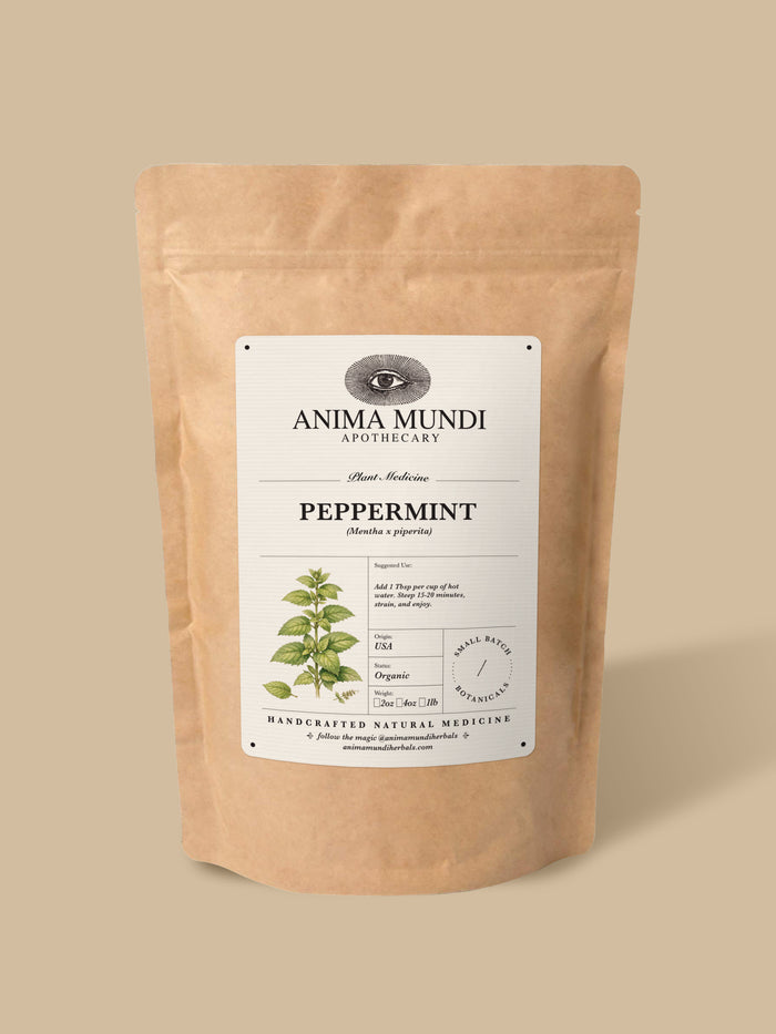 A kraft paper stand-up pouch of Anima Mundi Apothecary Peppermint herbal tea, set against a solid beige background.