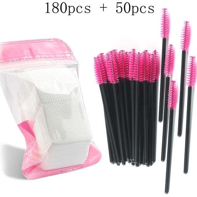 A collection of disposable eyelash brushes in various colors including black, pink, blue, and white, with plastic handles.