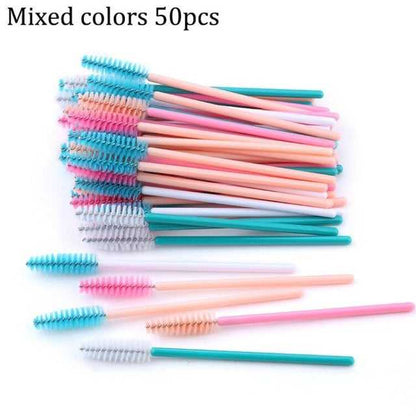 A collection of disposable eyelash brushes in various colors including black, pink, purple, blue, and white, with plastic handles.