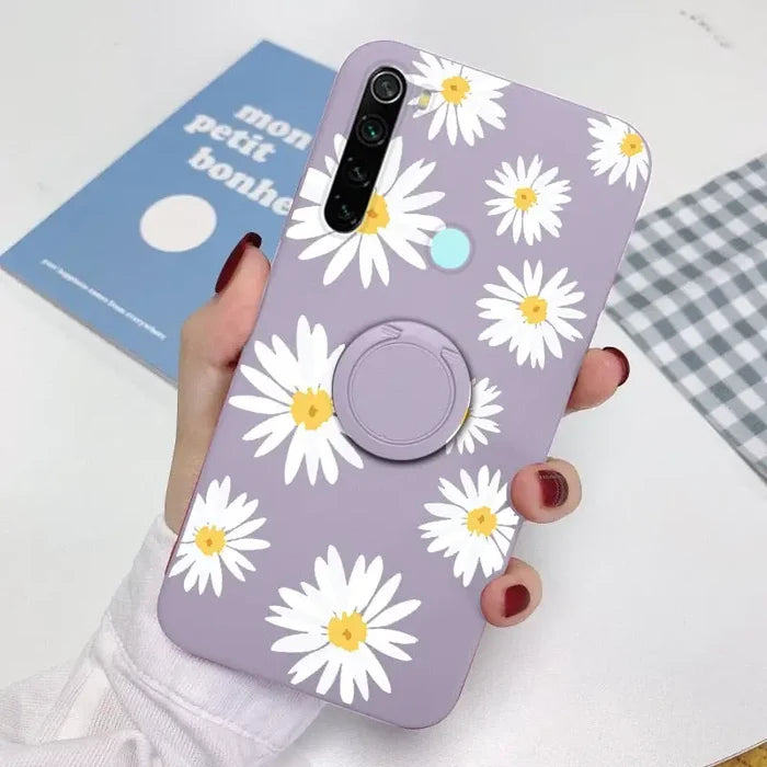 someone holding a purple phone with a white flower on it