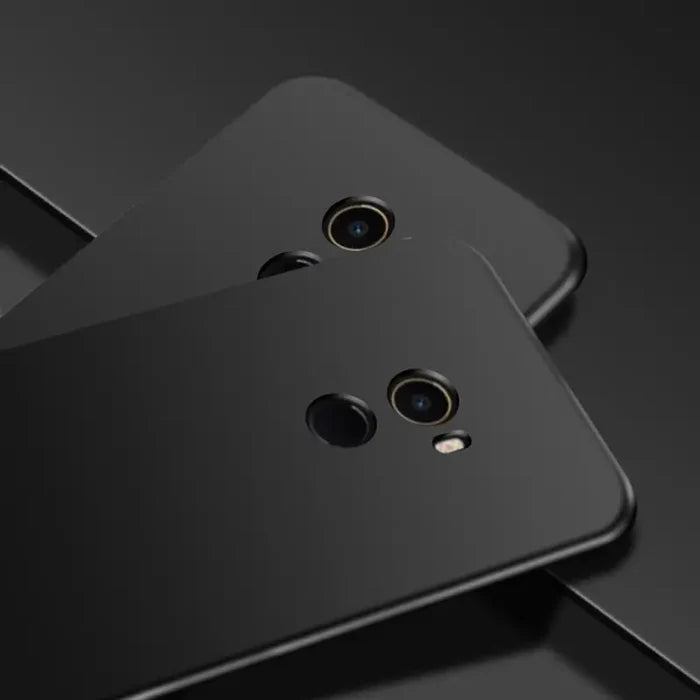 two black smartphones with one facing the camera and one facing the camera