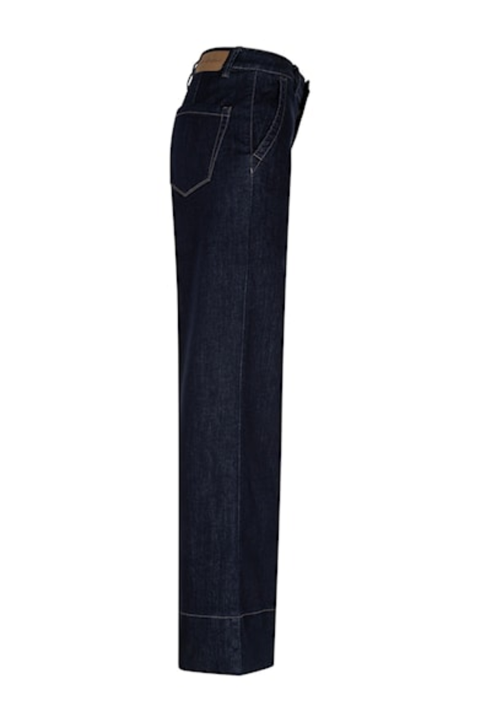 Dark blue denim jeans side view with back pocket stitching available to shop at Dotique