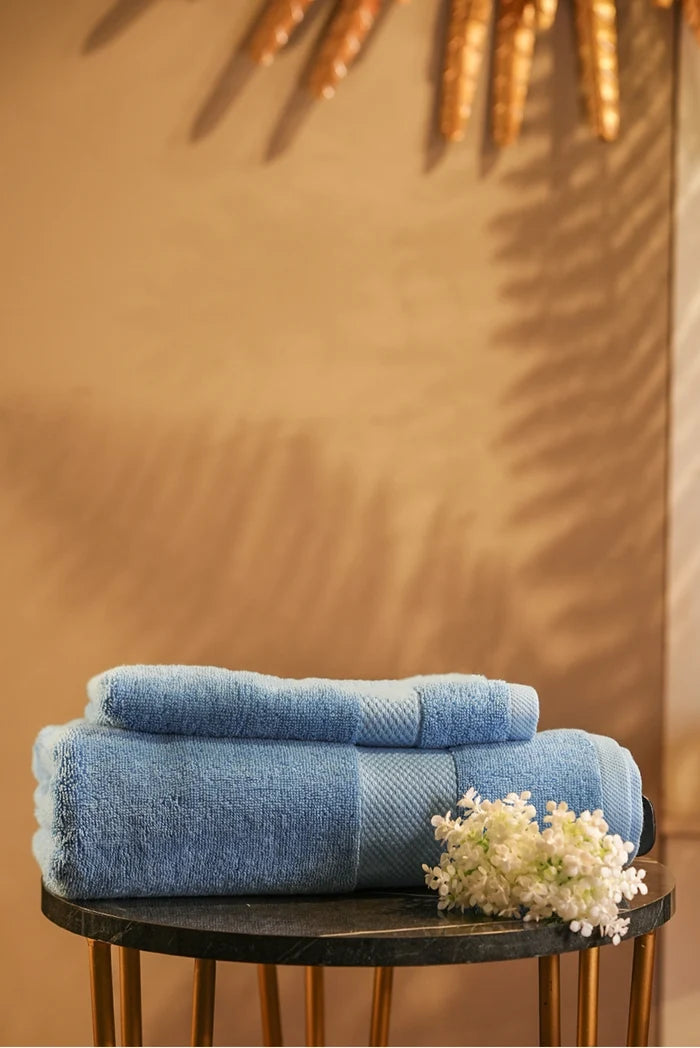 Sky-blue Pima cotton terry towel, two folded stacks