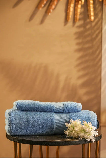 Sky-blue Pima cotton terry towel, two folded stacks