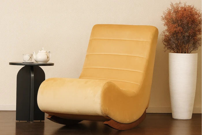 Yellow upholstered rocking chair with rounded arms and curved rocking base.
