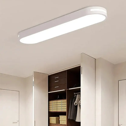 a white closet with a mirror and a light