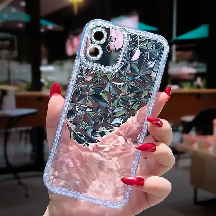 a woman holding a phone case with a diamond pattern