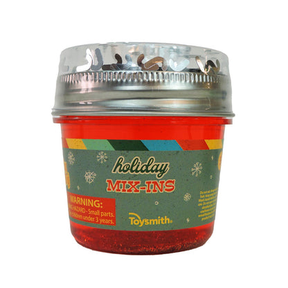 The Toysmith Deluxe Holiday Mix-In Slime is a festive red plastic container with holiday graphics and a silver lid, featuring a small parts warning for kids under 3—perfect as a Christmas sensory play gift.
