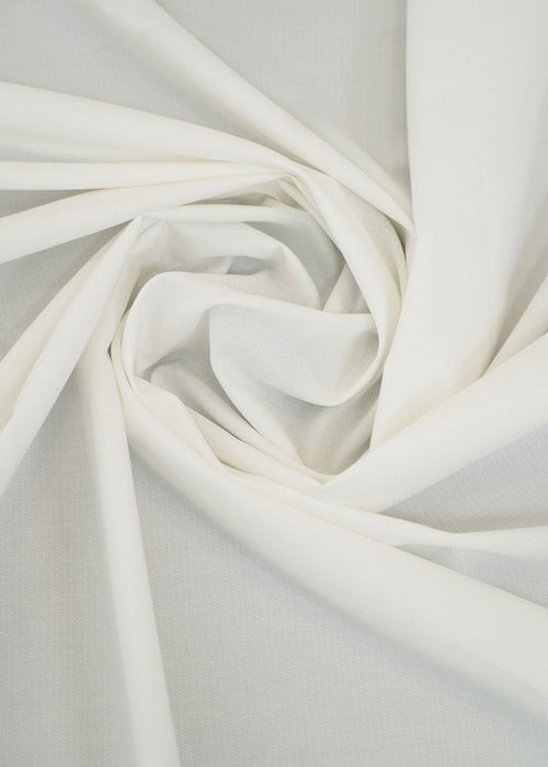 Off-white dobby fabric with woven texture, folded in soft folds