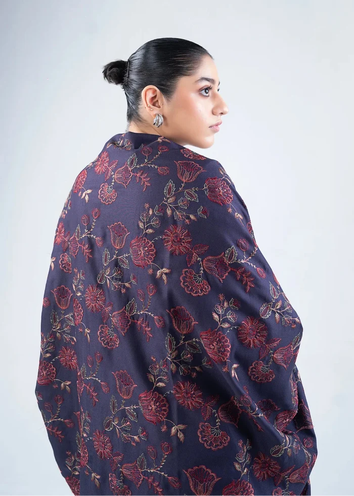 Women's wool winter shawl in dark navy with burgundy floral pattern, draped back view