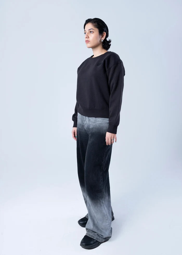 Black fleece crewneck sweatshirt with ribbed cuffs, side view