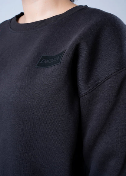 Black fleece sweatshirt chest logo patch, crewneck close-up